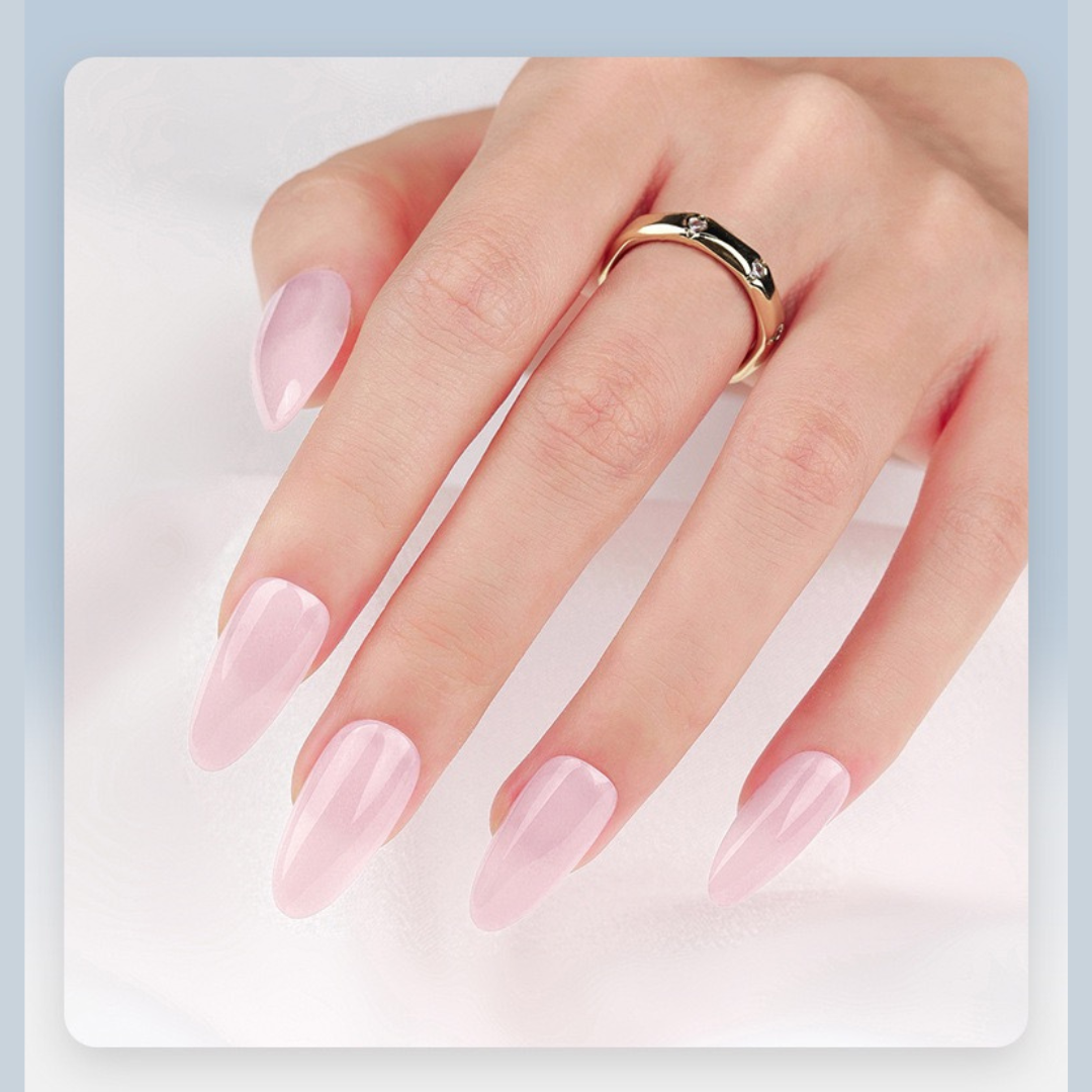 Hand with pink nail polish wearing a gold ring on a light blue background