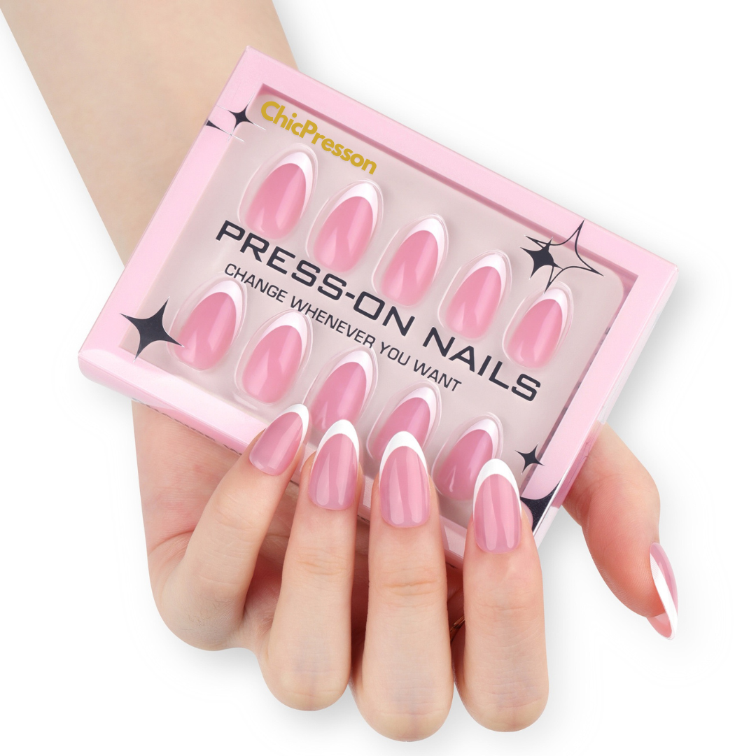 Pink press-on nails in a ChicPresson box held by a hand on a white background