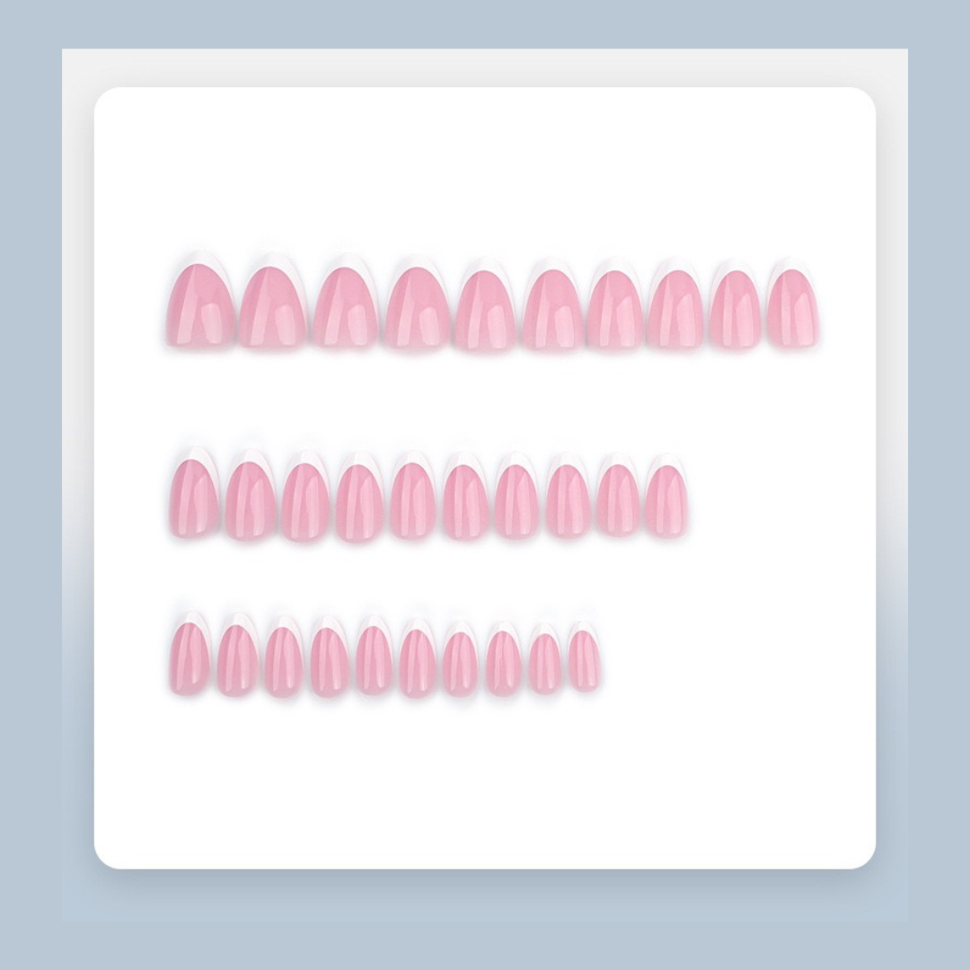 Set of pink false nails on a white tray with a light blue background