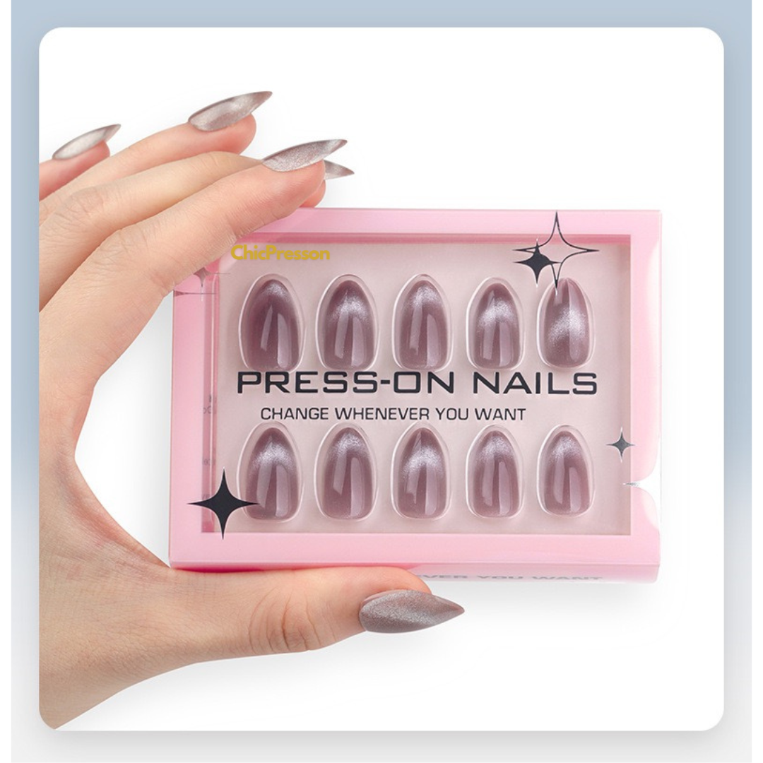 Box of press-on nails held by a hand with matching nails