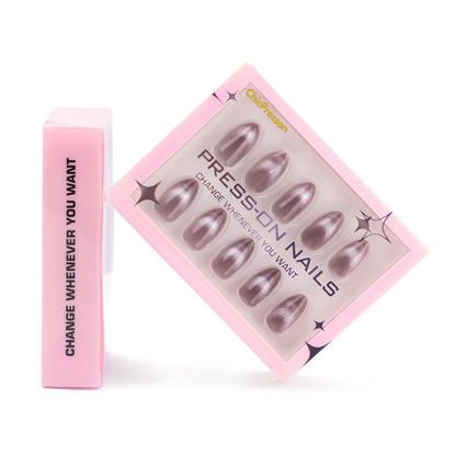Pink box of press-on nails with a pink applicator on a white background