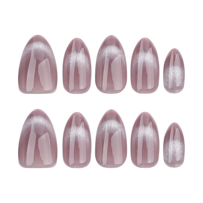 Set of pink nail extensions with a glittery finish on a white background