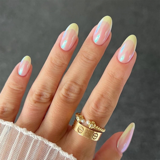 Hand with pastel gradient nail polish on a dark background