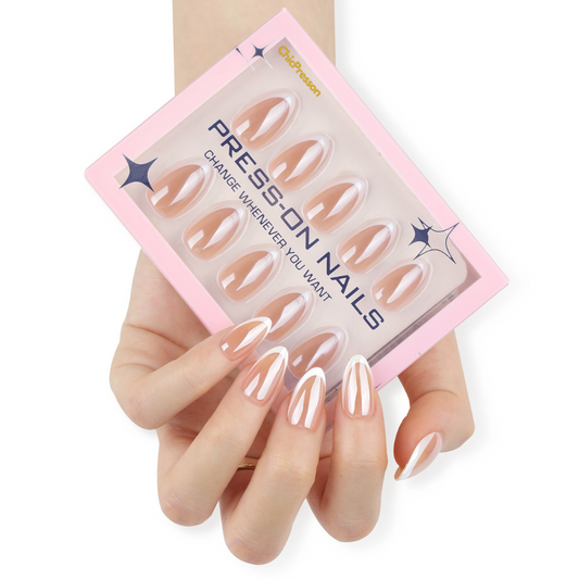 Set of press-on nails with a pink packaging box held by a hand.