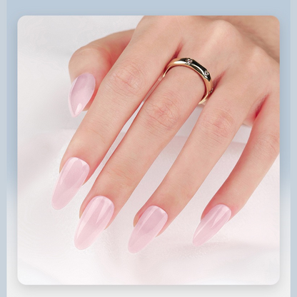 Hand with pink nail polish wearing a gold ring on a light blue background