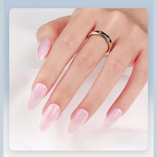 Hand with pink nail polish wearing a gold ring on a light blue background