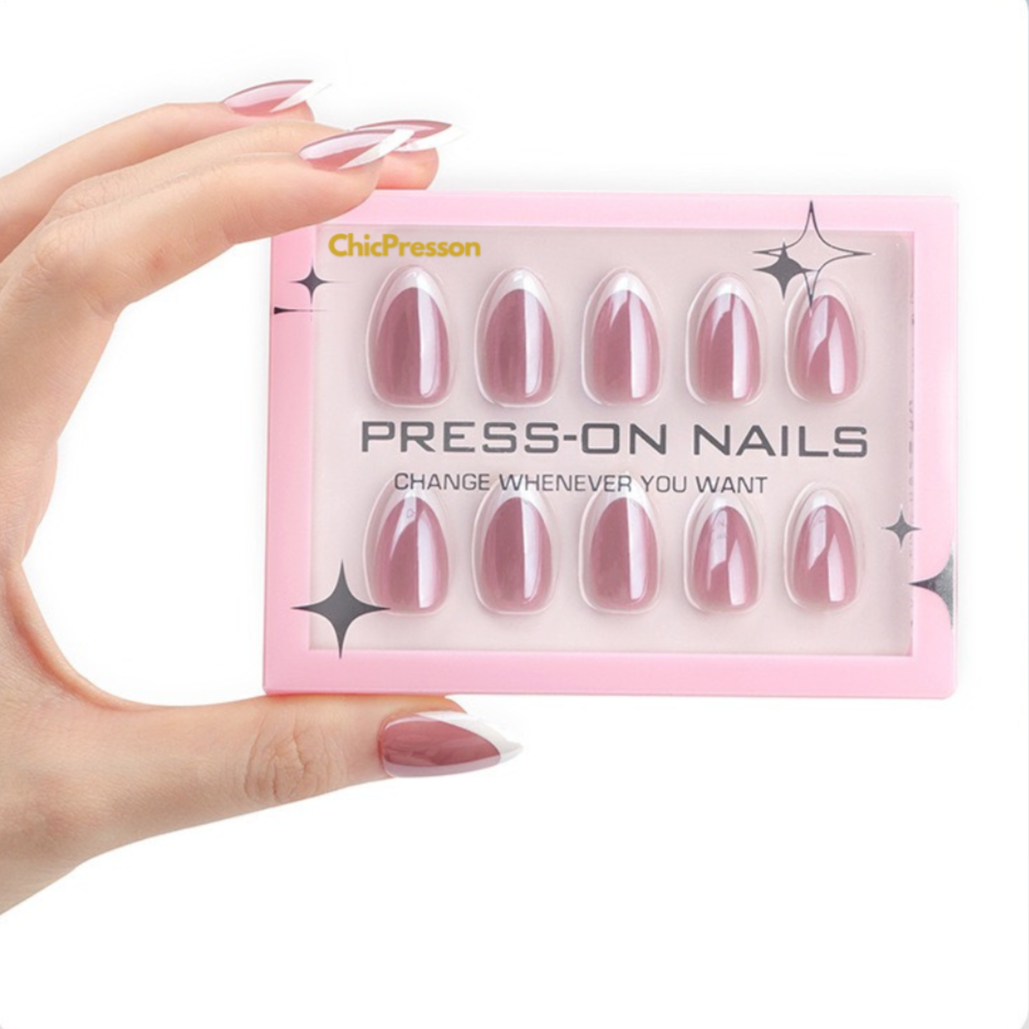Pack of press-on nails held by a hand with pink nails against a light blue background