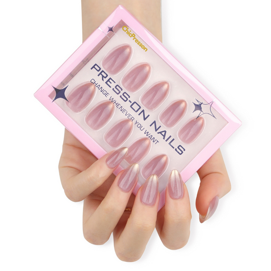 Press-on nails with a pink packaging box held by a hand on a white background